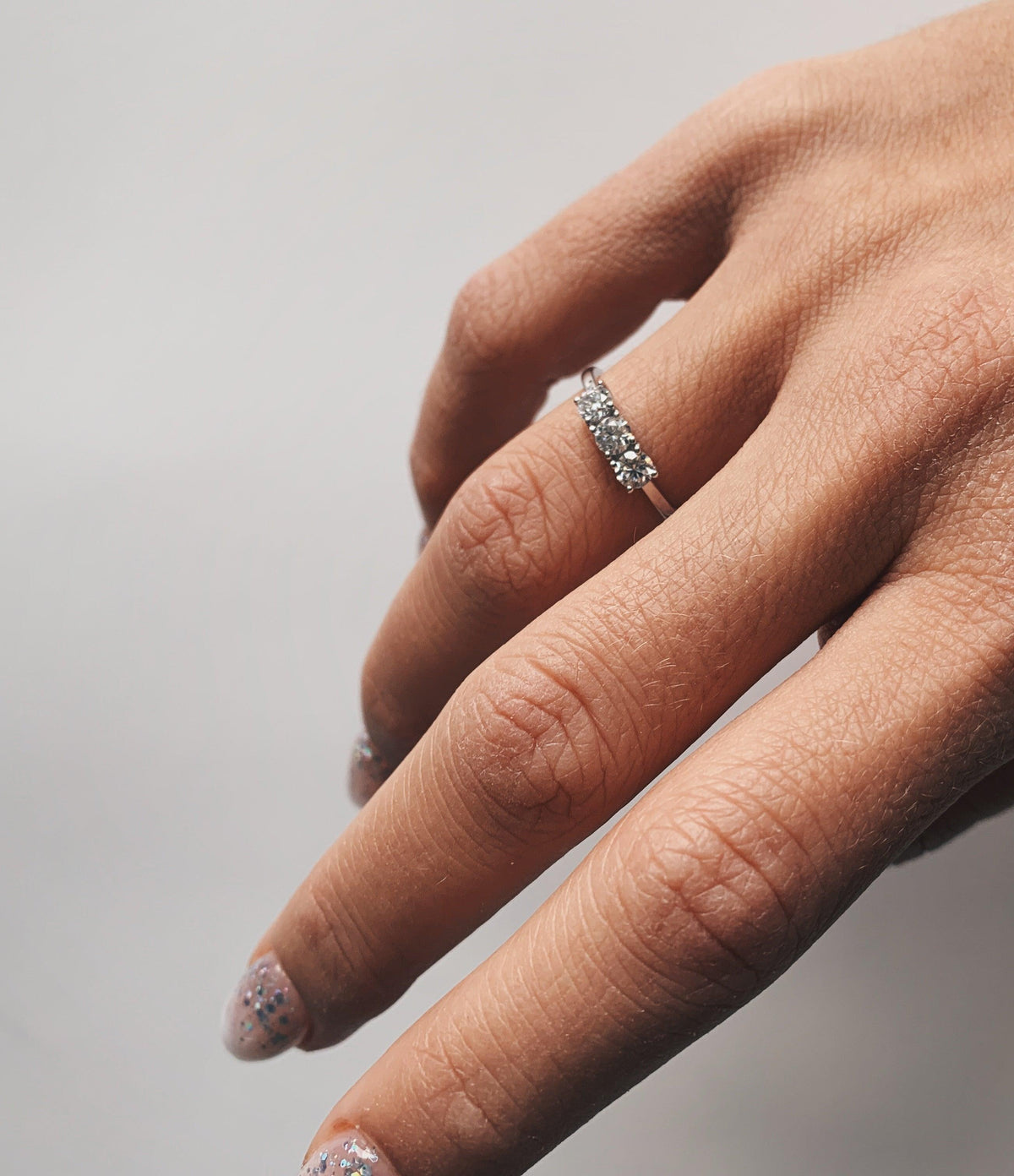 Moissanite White Gold Ring On A Woman's Finger