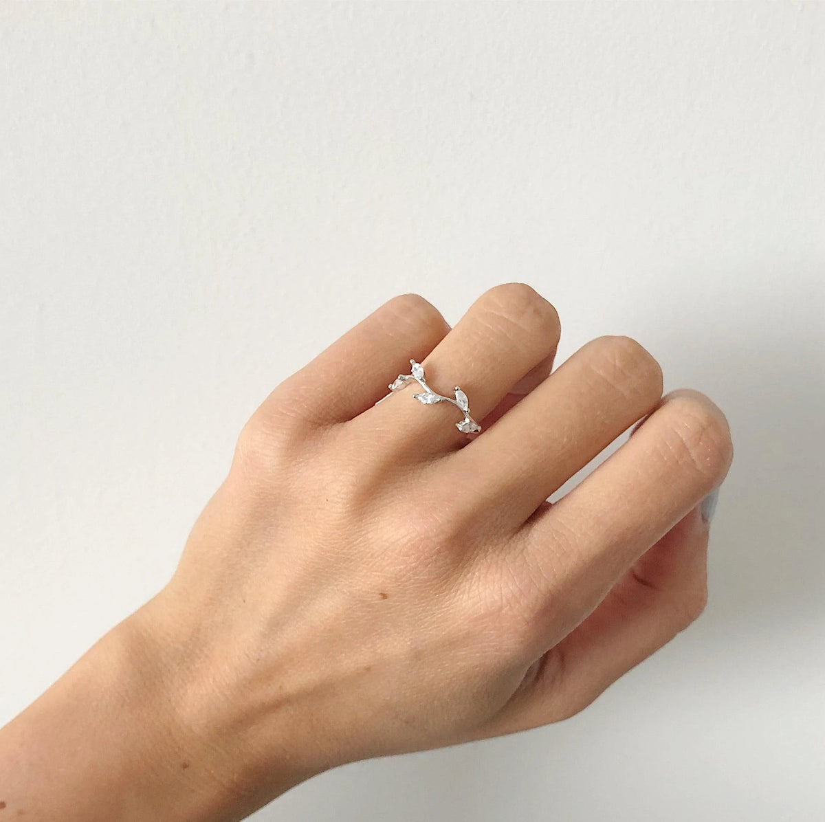 Dainty Leaf Cluster Ring On A Woman's Hand