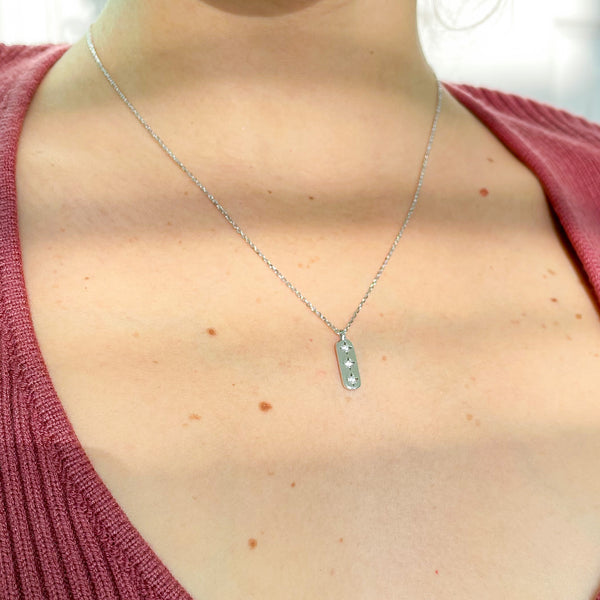 A Constellation Cartouche Necklace Made Of 925 Sterling SIlver On A Woman
